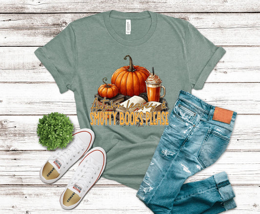 Green t-shirt with pumpkin design and text, paired with jeans and sneakers on a wooden surface.